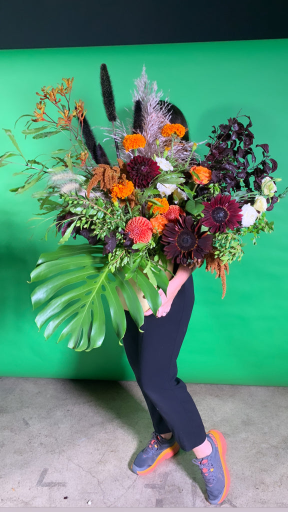 fancy arrangement with monstera in giants color scheme for special recipient
